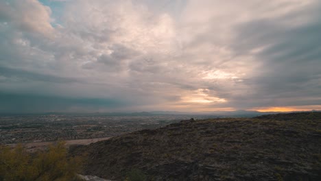 Timelapse-of-the-sunrise-with-heavy-moving-clouds-over-the-city-of-Phoenix,-Arizona-USA-in-4k