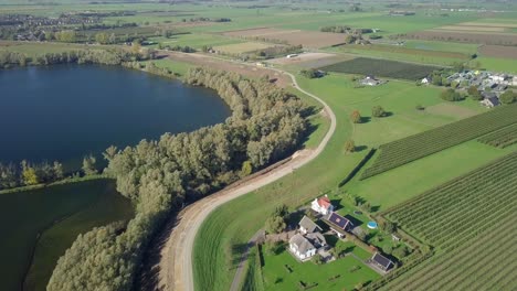 Aerial-drone-view-of-flying-over-the-beautiful-landscape-near-the-lake-in-the-Netherlands,-Europe
