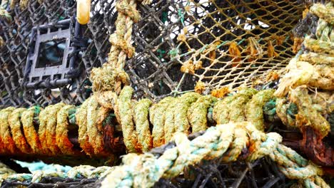 Stacked-empty-fishing-industry-lobster-net-baskets-dolly-right-closeup