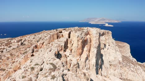 Aerial-flying-over-mountain-Cliffs-reveal-Mediterranean-deep-blue-sea-Scenery,-Greece