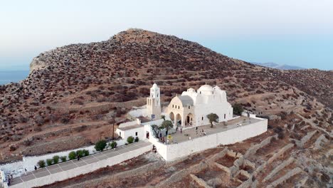 Aerial-descending-shot-famous-Panagia-Church-on-hilltop,-Folegandros-Island