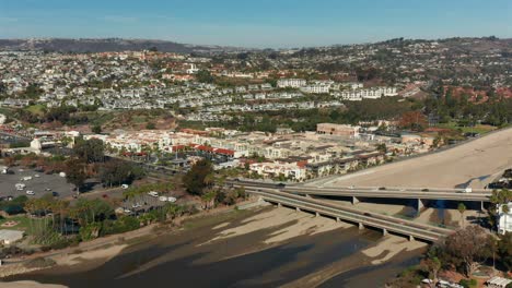 Aerial-view-of-traffic-on-the-overpass-and-hillside-housing-in-Dana-Point,-California