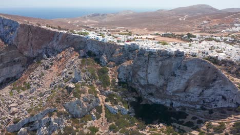 Aerial-ascending-greek-Coastal-Picturesque-town-sitting-on-cliff-edge-Landscape,-Greece