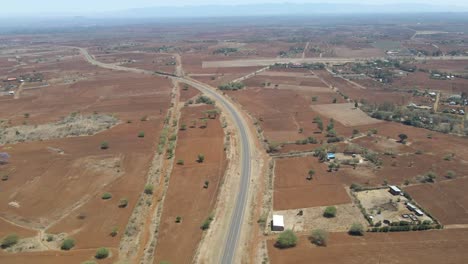 Long-aerial-of-calm-highway-in-rustic-Kenyan-countryside