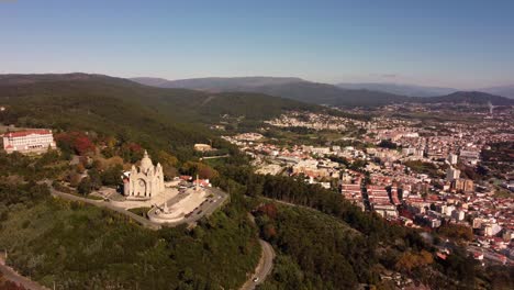 Drone-rotate-around-Viana-do-castelo-cathedral-old-town-with-epic-landscape-view-on-the-ocean-and-coastline-of-Portugal