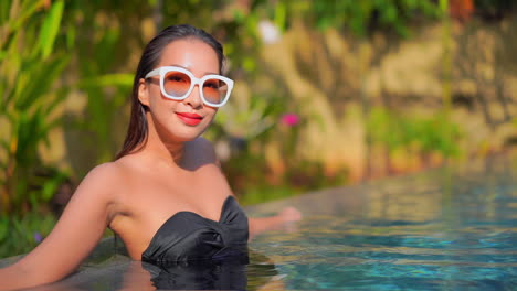 Nahaufnahme-Einer-Attraktiven-Frau-In-Einem-Swimmingpool-Mit-Riesigen-Weißen-Sonnenbrillen