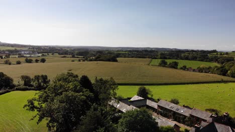 Aerial-panning-left-shot-of-farmland-and-Devon-Countryside-on-a-beautiful-summers-day
