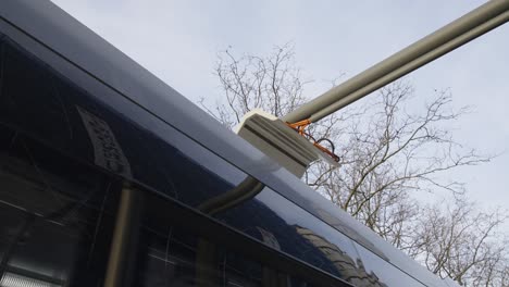Electric-bus-continues-to-ride-after-recharging-the-battery-at-the-renewable-energy-station---close-up