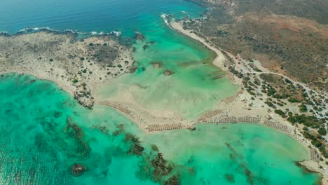 Aerial-tilt-up-From-beautiful-emerald-Water-Elafonissi-Beach-to-Mediterranean-horizon-Seascape