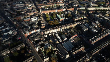 Aerial-View-of-Dublin,-Ireland,-Residential-Neighborhood,-Parnell-Square,-Church-and-Hospital-on-Sunshine-With-Clouds-Shades-Around,-High-Rise