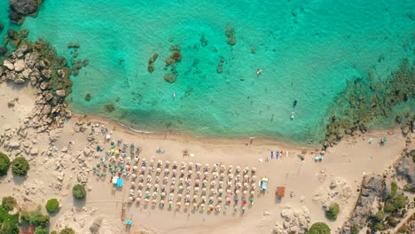 Top-down-view-descending-idyllic-scenery-crystal-clear-water,-sandy-Falasarna-beach,-Famous-destinations