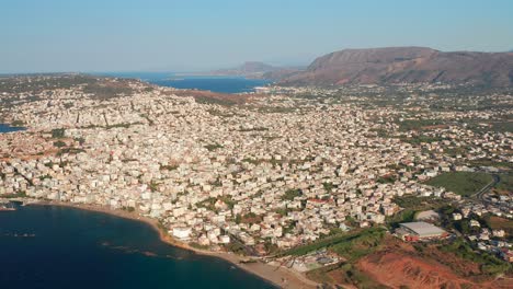 High-aerial-over-Chania-buildings-and-blue-water,-idyllic-Scene-of-Crete-Island---Greece