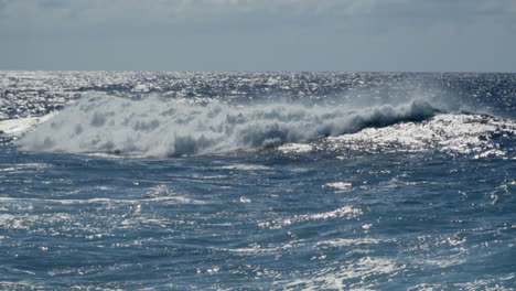 Powerful-waves-roll-in-and-break-off-shore-in-Atlantic-Ocean,-slow-motion