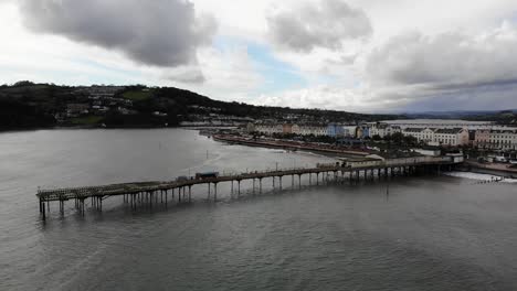 Aerial-View-Of-Teignmouth's-Grand-Pier,-Town-And-Shaldon