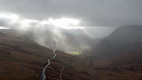 Panoramic-aerial-over-Snowdonia-National-Park-near-Llyn-Gwynant-Lake-in-Wales-with-atmospheric-rays-of-sun