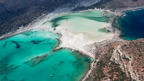 Aerial-pullback-revealing-mesmerizing-turquoise-water-landscape,-Balos-Beach-Coastline