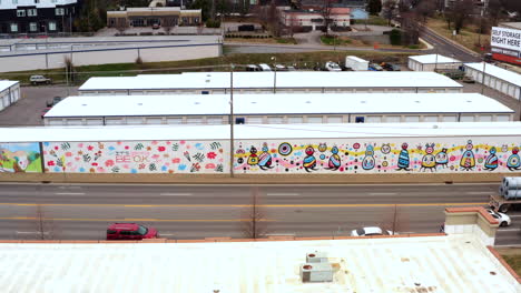 Aerial-tracking-shot-of-the-Off-the-Wall-Mural-collection-on-Charlotte-avenue,-Nashville-TN
