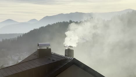 Smoke-rising-from-a-chimney-on-a-house-in-winter