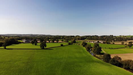 Aerial-backwards-shot-of-English-Countryside-on-a-beautiful-sunny-day