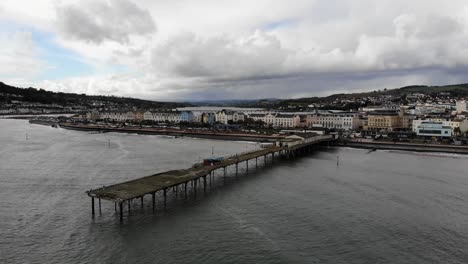 Aerial-shot-of-Teignmouth-Pier-and-seafront-in-Devon-England-on-a-overcast-day