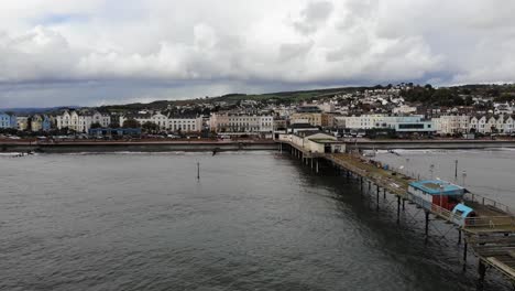 Aerial-backwards-shot-of-Teignmouth-Pier-in-Devon-on-a-cloudy-stormy-day