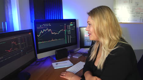 Happy-female-stock-broker-trader-looking-a-charts