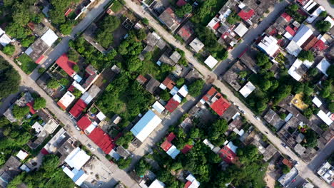Aerial-wide-view-of-the-city-of-Oaxaca-in-Mexico,-filmed-by-a-drone-with-top-down-displacement,-showing-a-poor-area-and-shack-homes