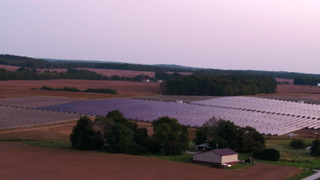 Aerial-view-of-solar-farm-array-bordering-residential-property,-located-in-White-County,-Southern-Illinois