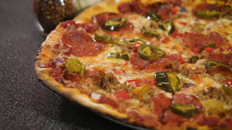 Classic-thin-crust-pepperoni-pizza-with-jalapenos,-close-up-slider-4K