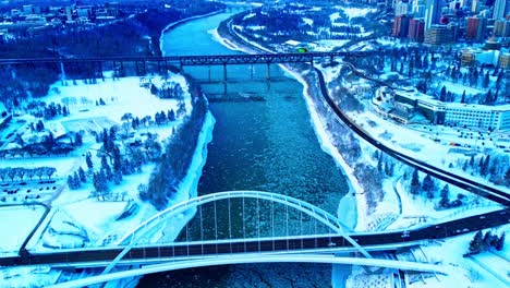 Winter-aerial-over-the-Walter-Dale-Bridge-dolly-roll-hold-over-the-west-view-reveal-the-High-Level-bridge-as-ice-pieces-in-the-North-Saskatchewan-river-in-between-Kinsmen-park-and-the-Alberta-Treasury