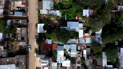Aerial-close-up-view-of-the-city-of-Oaxaca-in-Mexico,-filmed-by-a-drone-with-top-down-displacement,-showing-a-poor-area-and-shack-homes
