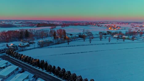 An-Aerial-View-Across-Countryside-Farmlands-and-a-Mobile,-Manufactured,-Modular-Home-Park-After-a-Early-Morning-Snow-Fall-During-the-Golden-Hour