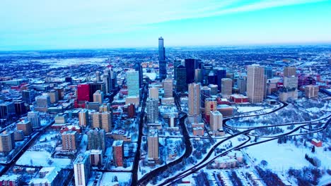 Winter-Luftüberführung-Downtown-Edmonton-Mit-Blick-Auf-Die-Gebäude-Von-Der-Südseite-Zur-Nordseite-Schneebedeckte-Wolkenkratzer-Parks-An-Der-Skyline-Mit-Dem-Alten-Flughafen-Im-Hintergrund-Ausgeräumt1-3