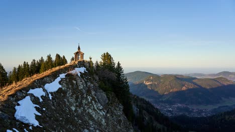 Golden-hour-timelapse-of-the-Freudenreich-chapel-on-the-ridge-of-Brecherspitz,-a-famous-hiking-destination-in-the-mountains-of-the-alps-in-Bavaria,-Germany