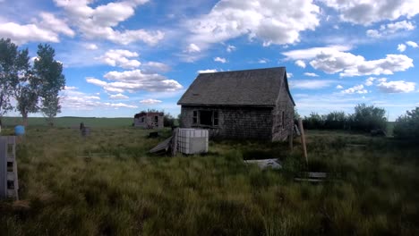 Small-old-abandoned-house-in-the-prairies-near-Alberta-Canada-on-a-cloudy-day-with-a-will-sky