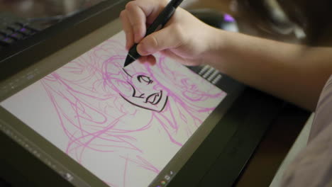 A-caucasian-woman's-hand-draws-a-digital-illustration-on-a-tablet-in-slow-motion