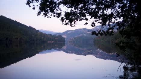 Peneda-Gerês-with-water-reflection-of-mountains-and-houses-in-background