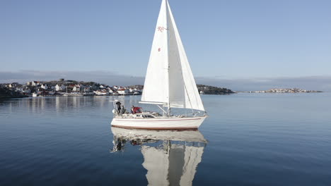 Close-up-shot-of-a-big-beautiful-white-sail-boat-outside-a-port-at-Öckerö-Island-Municipality-in-Gothenburg-archipelago,-Sweden