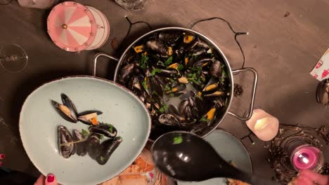 Top-view-of-group-of-people-serving-fresh-Mussels