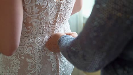 Woman-Adjusting-Bridge-In-Beautiful-White-Lace-Dress-On-Wedding-Day