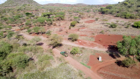 Cinematic-Aerial-of-truck-driving-past-farmlands-in-rural-Kenya