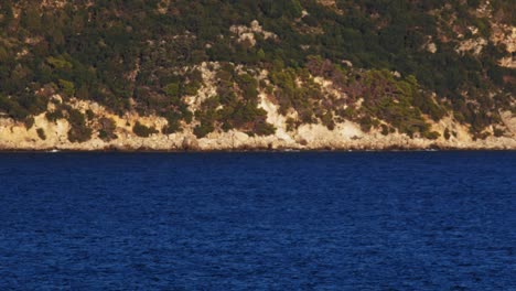 Üppige-Klippen-Mit-Riesigem-Blauem-Meerwasser-Am-Strand-Von-Agia-Kiriaki-In-Griechenland---Weitschuss