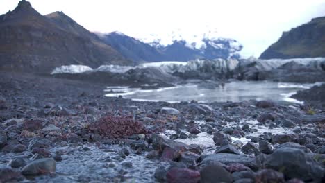 Water-rivulets-flowing-over-stones,-Skaftafell-glacier-in-Iceland