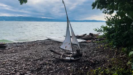 Self-made-ship-made-out-of-wood-in-front-of-big-lake-in-Germany,-Bodensee