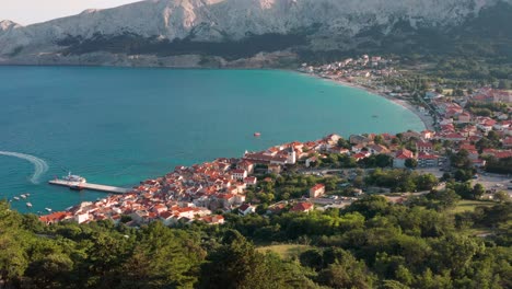 Aerial-arc-shot-above-the-town-of-Baska-on-Krk-Island-looking-out-to-the-bay