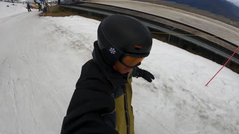 Asian-Man-Filming-Self-While-Skiing-On-Snowy-Ski-Resort-At-Coronet-Peak-In-Queenstown,-New-Zealand