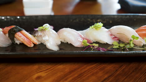 Colorful-unique-line-of-traditional-nigiri-on-elegant-sushi-platter,-slider-4K
