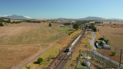 Local-Train-Running-Through-Stellenbosch-Town,-Wine-Estate-In-Western-Cape,-South-Africa