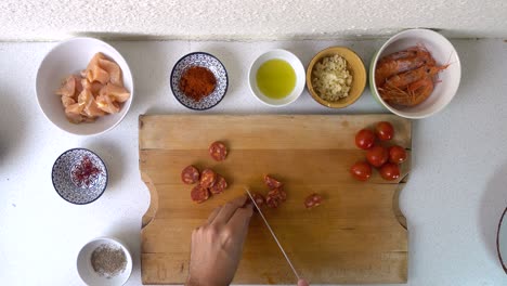 Top-down-tasty-style-video-of-male-hands-cutting-chorizo-into-pieces