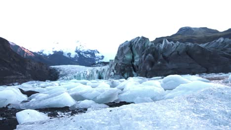 Chunks-of-ice-between-rocks-of-Skaftafell-glacier-in-Iceland-at-dawn